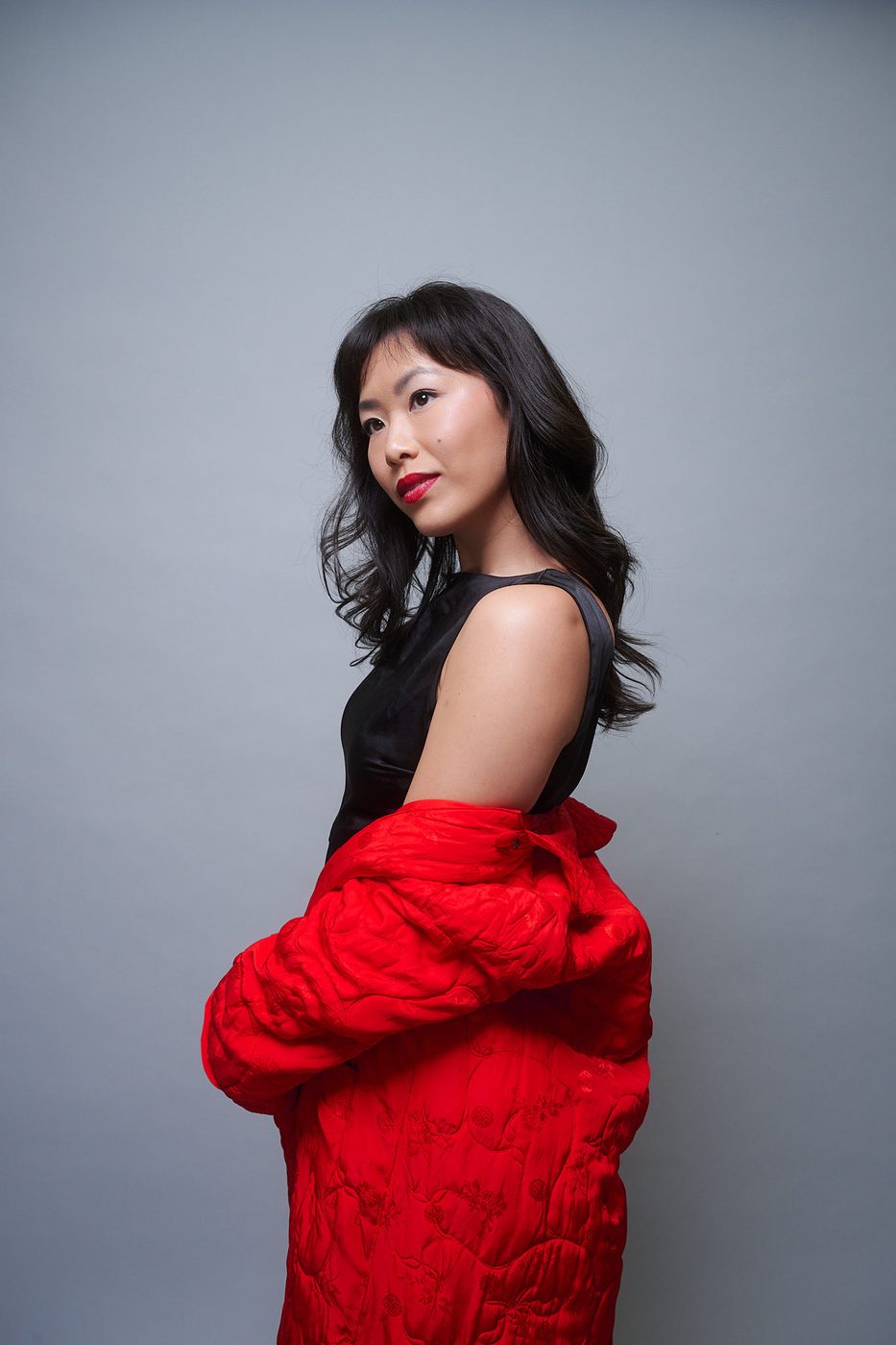 Ashley Chiu, Asian American actress and producer, in red and black